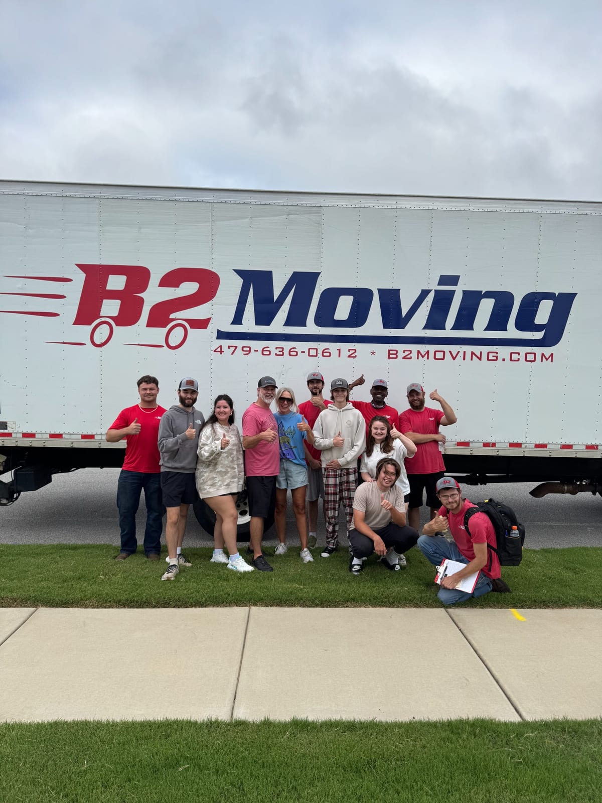 Dolph, Bradley, Jodie, Joe, and Kaden with customers after completing a Cave Springs move
