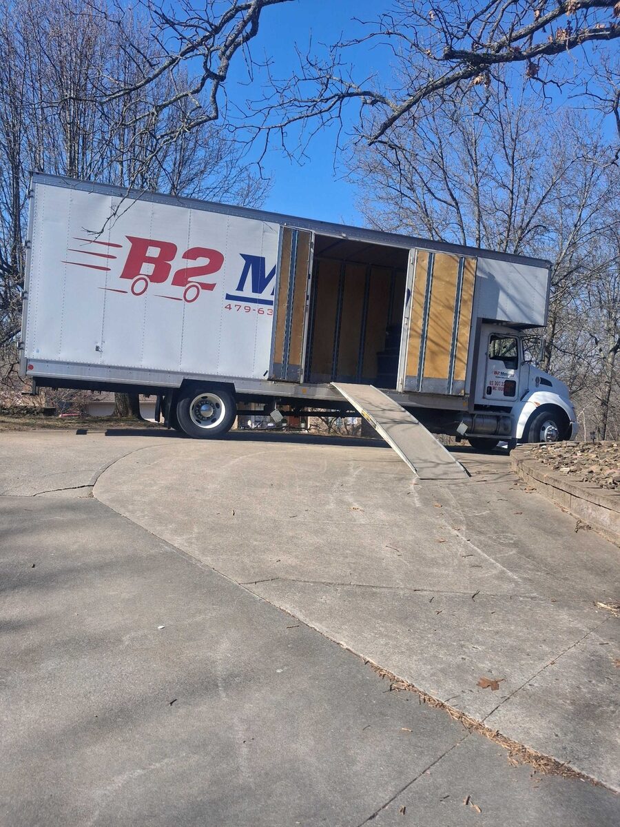 B2 Moving truck using its side-loading door and ramp on a steep driveway