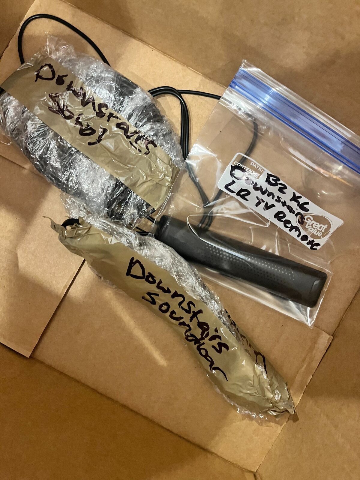 Small furniture and electronics parts individually wrapped, bagged, and labeled by a B2 moving crew