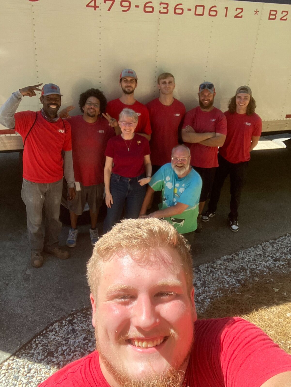 Happy customers with B2 Moving crew members after delivery in Northwest Arkansas